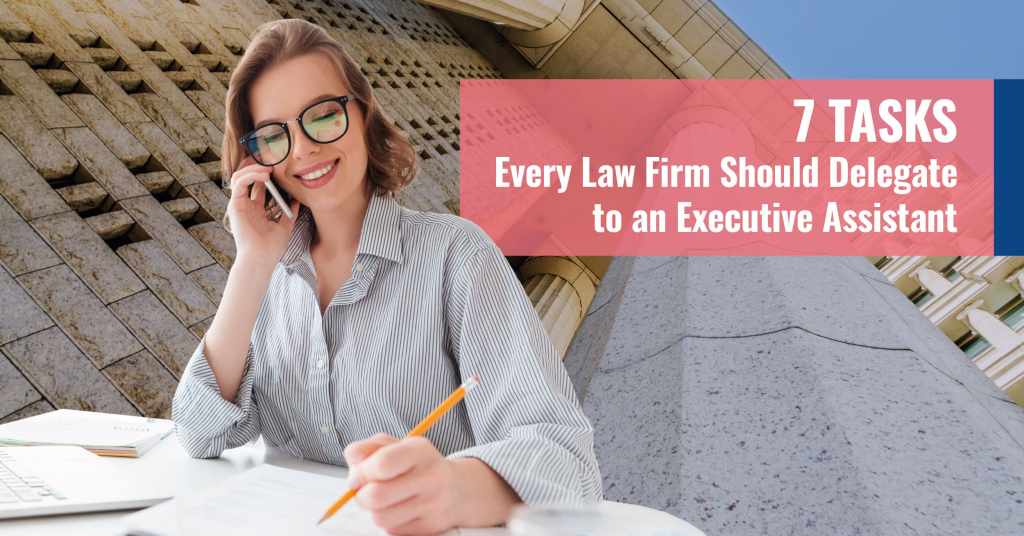 Smiling executive assistant on the phone working at a desk, representing the seven key tasks law firms should delegate to improve productivity.