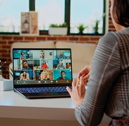 Professional virtual workshop meeting displayed on a laptop screen, featuring diverse participants in a video conference for a law firm leadership and networking session.